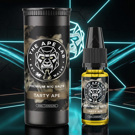 A bottle of Tarty Ape Premium Nic Salts e-liquid next to its black cylindrical packaging container, both featuring a black and gray camouflage pattern with a white circular logo for 'The Ape Lab'. The background is a dark studio setting with glowing cyan geometric lines.